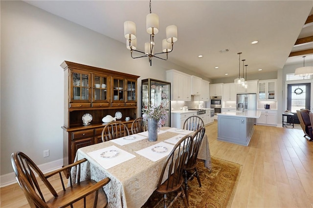 dining area featuring recessed lighting, visible vents, baseboards, light wood finished floors, and an inviting chandelier