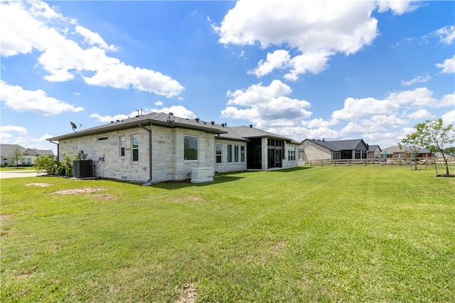 10724 Harvey Ranch Rd, College Station, TX 77845 - back of house with stone siding and a sunroom
