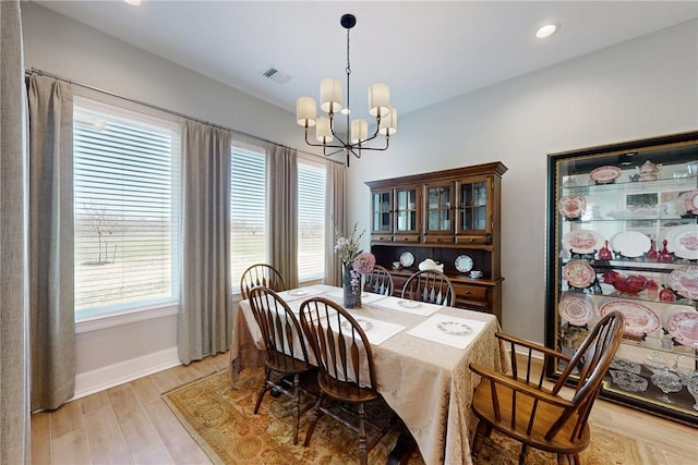 dining area featuring light wood-style flooring, recessed lighting, visible vents, baseboards, and an inviting chandelier