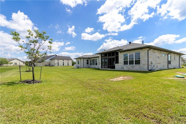 10724 Harvey Ranch Rd, College Station, TX 77845 - rear view of property with stone siding, a yard, and a sunroom