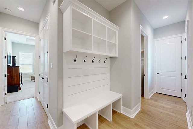 mudroom featuring light wood-style floors, baseboards, and recessed lighting