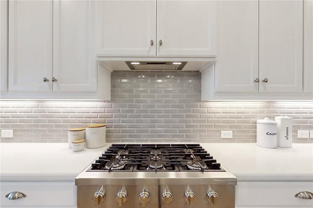 room details featuring white cabinets, stainless steel gas stovetop, and light countertops