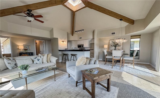 1406 Broken Hls Unit 14, Horseshoe Bay, TX 78657 - living area with high vaulted ceiling, ceiling fan, baseboards, beam ceiling, and a chandelier