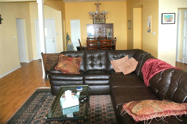 231 Memphis Belle Ln, Trinity, TX 75862 - living room featuring a chandelier, wood finished floors, and baseboards