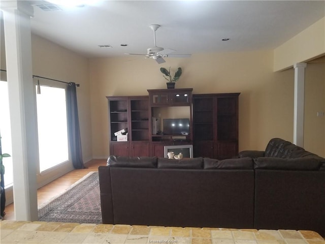 231 Memphis Belle Ln, Trinity, TX 75862 - living room featuring ceiling fan and decorative columns