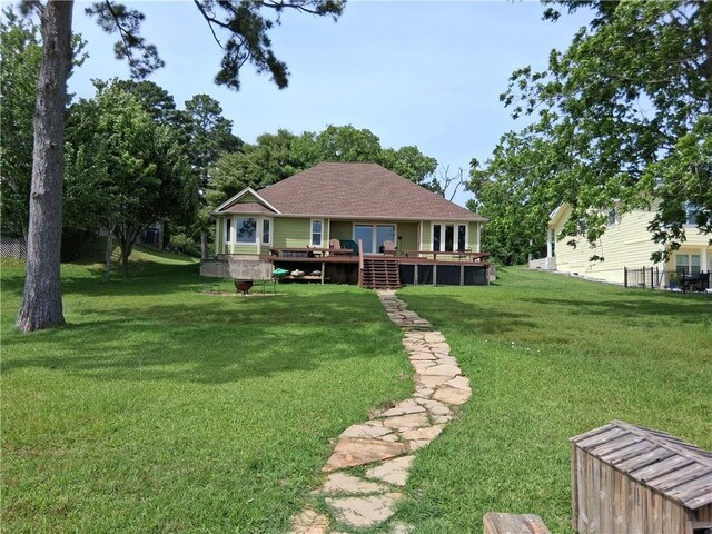 231 Memphis Belle Ln, Trinity, TX 75862 - rear view of property with a deck, a yard, and roof with shingles