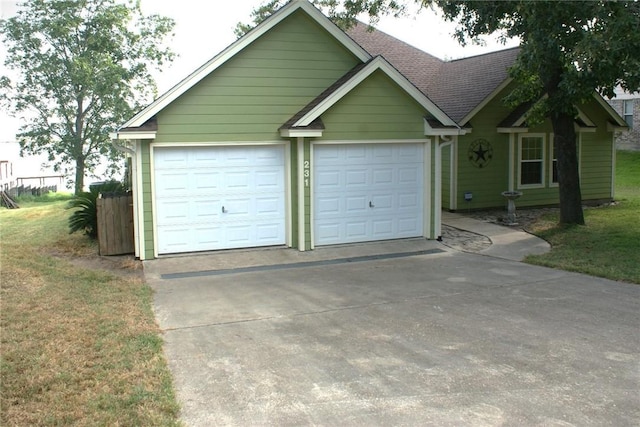 231 Memphis Belle Ln, Trinity, TX 75862 - single story home featuring driveway, a front yard, a garage, and a shingled roof