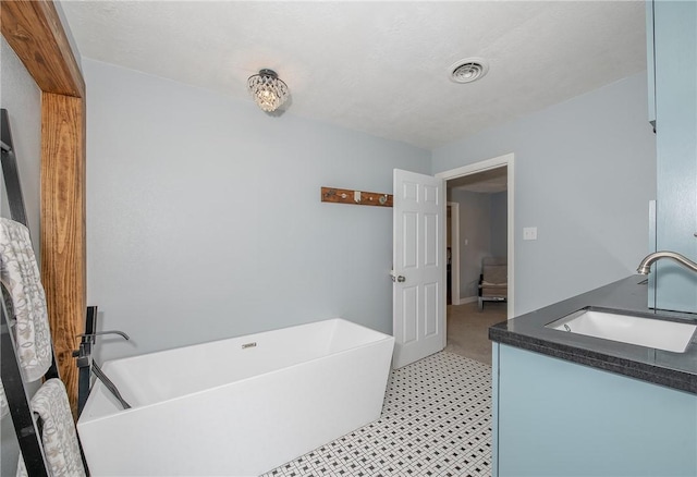 bathroom with vanity and a tub