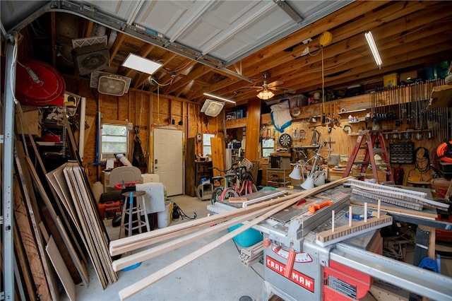 garage with a workshop area and ceiling fan