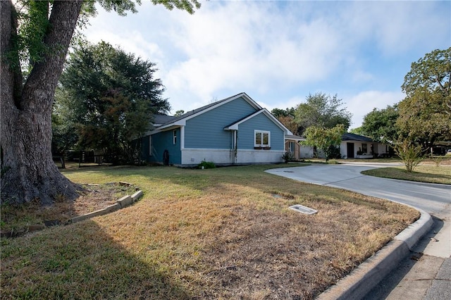 view of side of property with a yard