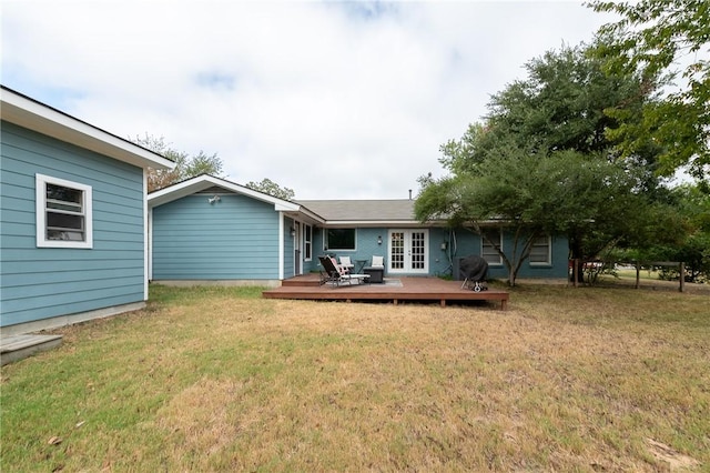 back of property with a wooden deck and a yard