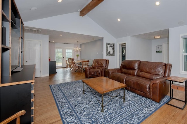 living room featuring vaulted ceiling with beams, hardwood / wood-style floors, and french doors