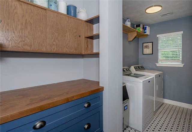 clothes washing area with washing machine and dryer