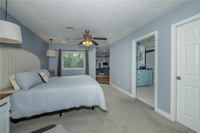 carpeted bedroom featuring ceiling fan and a textured ceiling