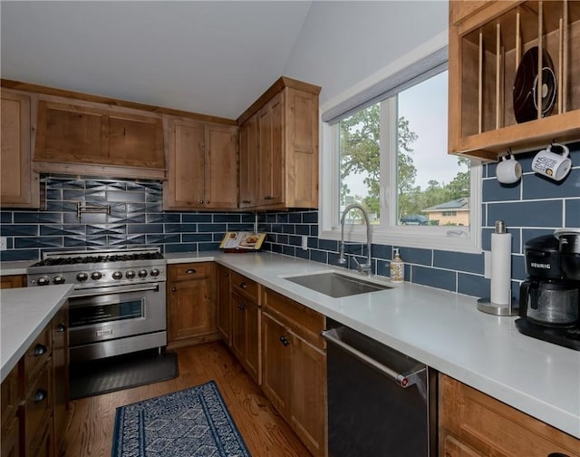 kitchen with dark hardwood / wood-style flooring, sink, appliances with stainless steel finishes, and tasteful backsplash