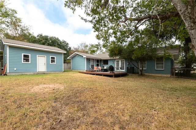 back of property featuring a lawn, central AC, and a wooden deck