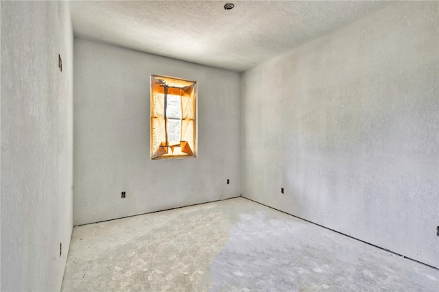 1403 Clark St, Bryan, TX 77808 - spare room featuring unfinished concrete floors and a textured ceiling