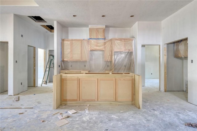 1403 Clark St, Bryan, TX 77808 - kitchen featuring light brown cabinets and a textured ceiling