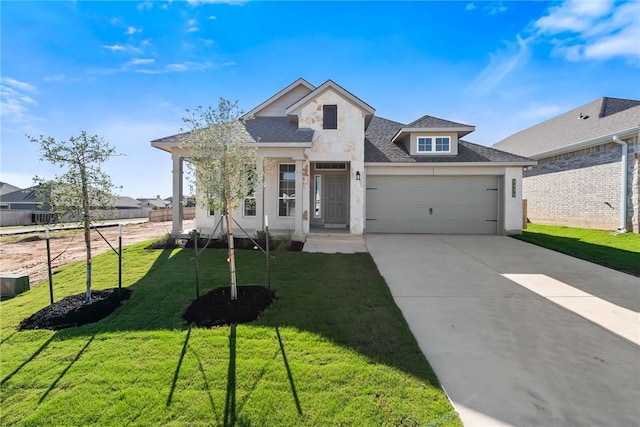 view of front of property featuring a front yard and a garage