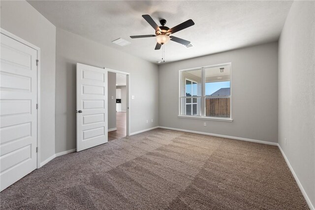 unfurnished bedroom with carpet floors and ceiling fan