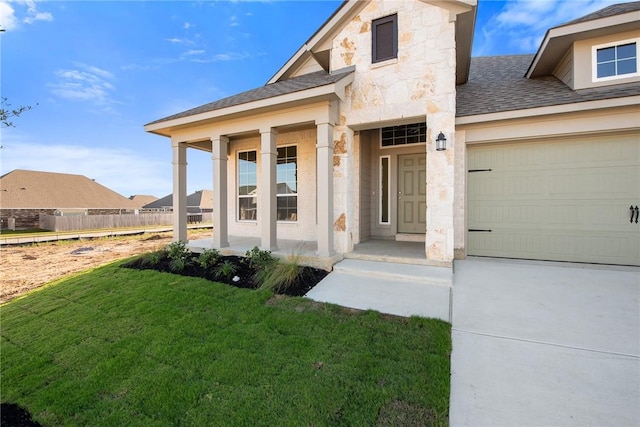 property entrance with covered porch, a garage, and a yard