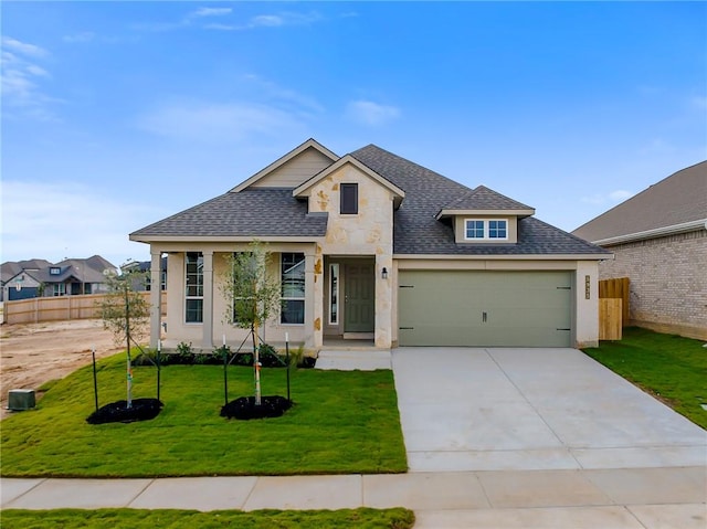 view of front of property featuring a front yard and a garage