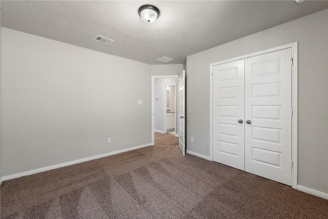 unfurnished bedroom featuring carpet flooring and a closet