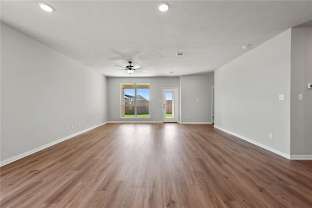 unfurnished room with ceiling fan and wood-type flooring