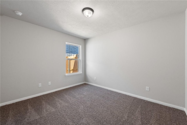 carpeted empty room with a textured ceiling