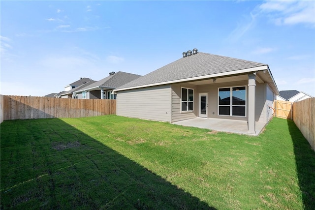 rear view of house with a patio area and a lawn