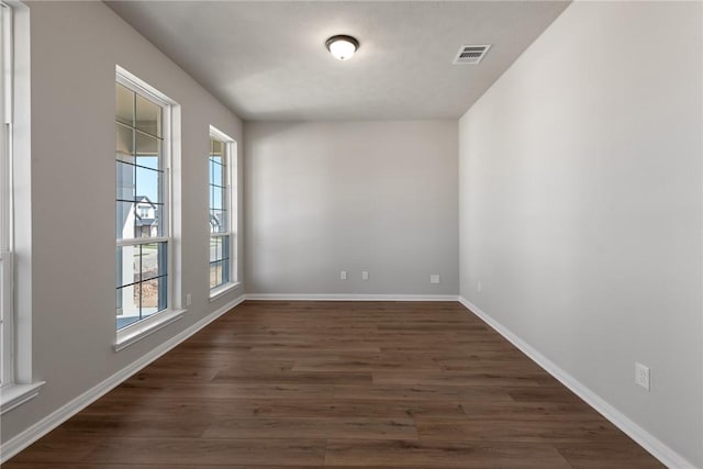 spare room with dark wood-type flooring