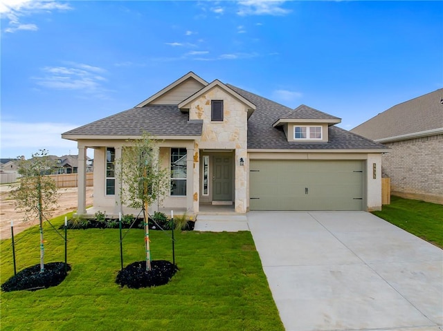 view of front of home with a front yard and a garage