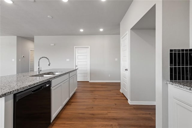 kitchen with dark hardwood / wood-style flooring, light stone counters, sink, black dishwasher, and white cabinetry