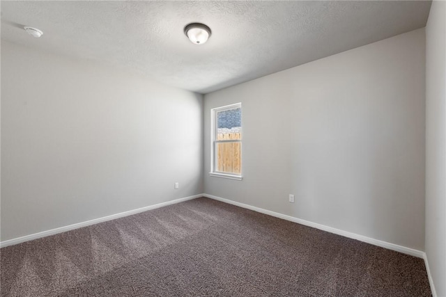 empty room featuring carpet flooring and a textured ceiling