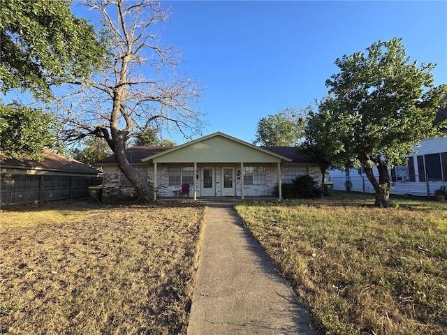 view of front of home with covered porch and a front yard