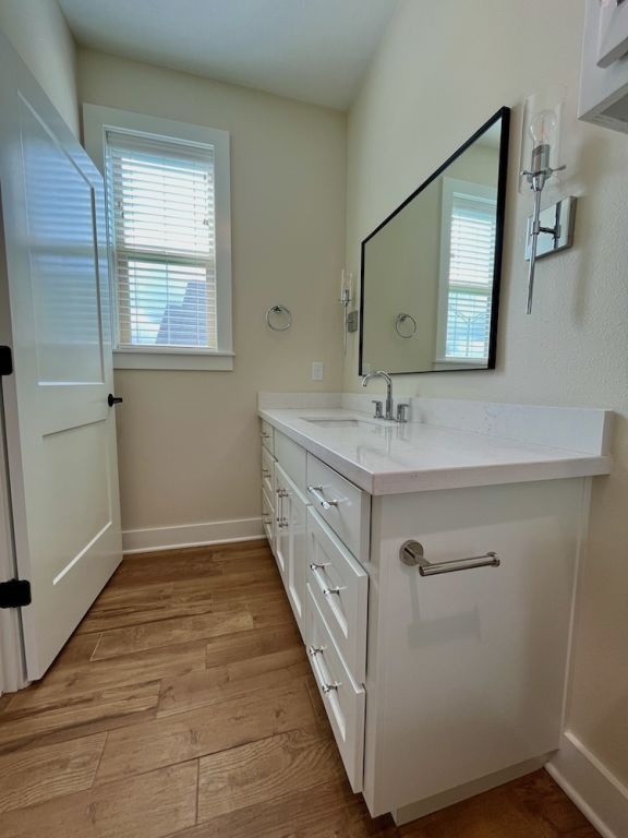 2016 R A Galindo Blvd, Bryan, TX 77807 - bathroom with wood finished floors, baseboards, and vanity