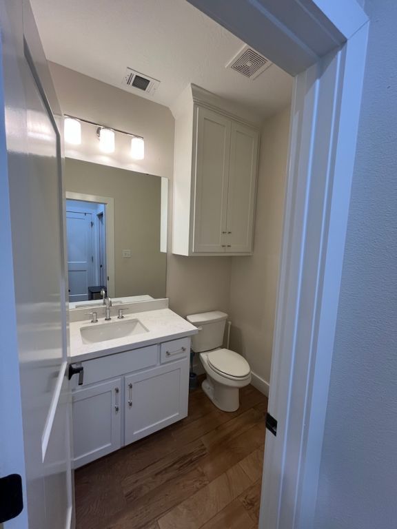 2016 R A Galindo Blvd, Bryan, TX 77807 - bathroom with toilet, wood finished floors, and vanity