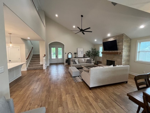 2016 R A Galindo Blvd, Bryan, TX 77807 - living room featuring ceiling fan, healthy amount of natural light, stairs, wood finished floors, and high vaulted ceiling