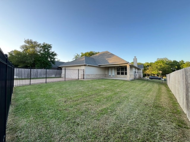 2016 R A Galindo Blvd, Bryan, TX 77807 - back of house with driveway, a chimney, and a garage