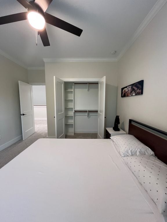 2016 R A Galindo Blvd, Bryan, TX 77807 - bedroom with crown molding, carpet flooring, baseboards, a ceiling fan, and a closet