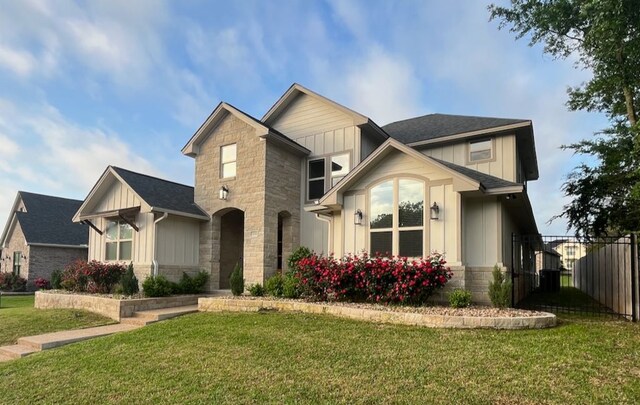 2016 R A Galindo Blvd, Bryan, TX 77807 - view of front of property featuring board and batten siding, stone siding, and roof with shingles