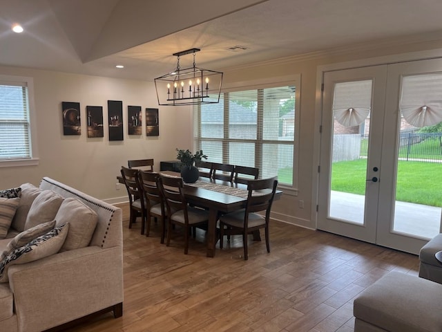 2016 R A Galindo Blvd, Bryan, TX 77807 - dining area with healthy amount of natural light, ornamental molding, wood finished floors, recessed lighting, and french doors