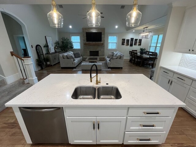2016 R A Galindo Blvd, Bryan, TX 77807 - kitchen featuring a sink, dishwasher, open floor plan, arched walkways, and recessed lighting