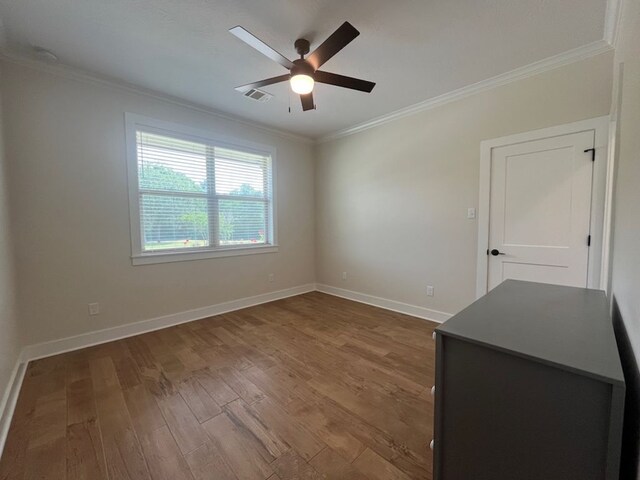 2016 R A Galindo Blvd, Bryan, TX 77807 - unfurnished room with crown molding, ceiling fan, wood finished floors, and baseboards