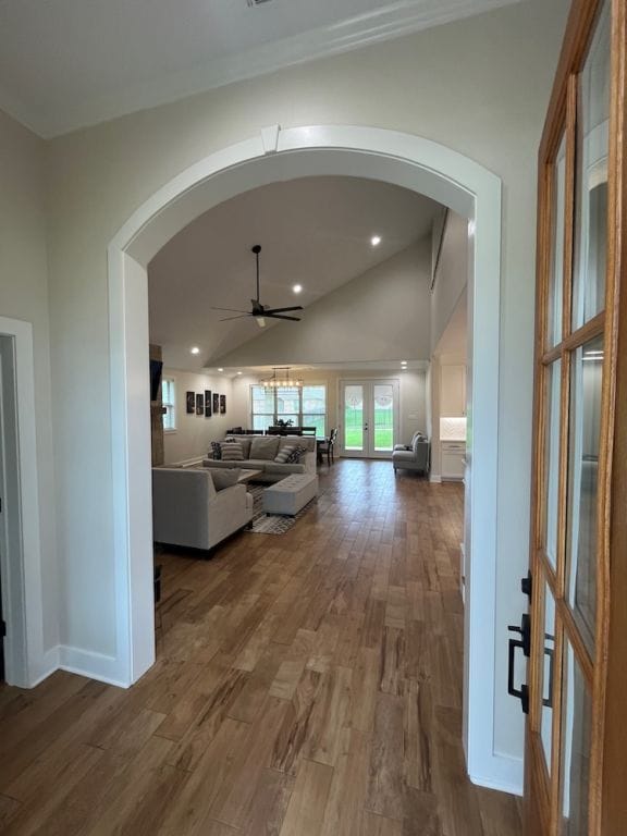 2016 R A Galindo Blvd, Bryan, TX 77807 - hall featuring arched walkways, dark wood finished floors, baseboards, lofted ceiling, and recessed lighting