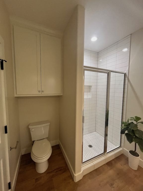 2016 R A Galindo Blvd, Bryan, TX 77807 - full bath featuring a shower stall, wood finished floors, baseboards, and recessed lighting