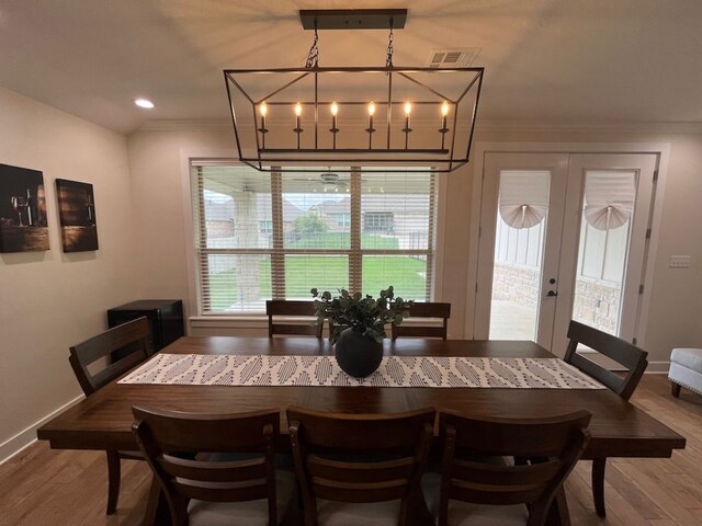 2016 R A Galindo Blvd, Bryan, TX 77807 - dining area with crown molding, wood finished floors, baseboards, french doors, and recessed lighting