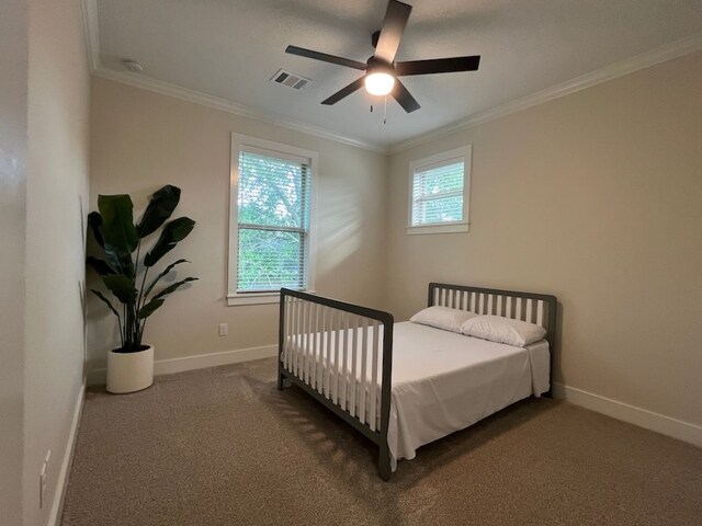 2016 R A Galindo Blvd, Bryan, TX 77807 - bedroom with ornamental molding, baseboards, dark colored carpet, and ceiling fan