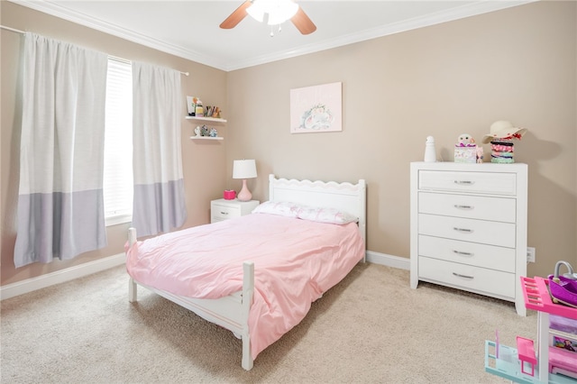 carpeted bedroom featuring crown molding, a ceiling fan, and baseboards