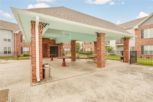 view of patio featuring a ceiling fan and fence